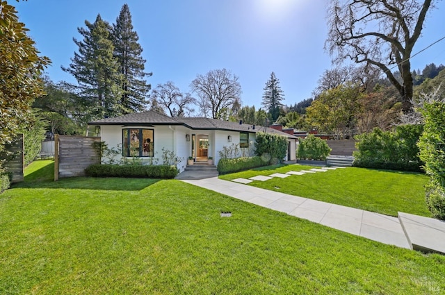 view of front of property with a front lawn and fence