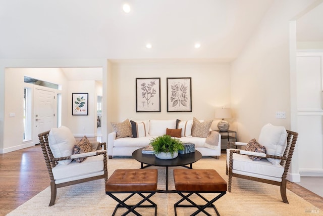 living area featuring recessed lighting, baseboards, and light wood finished floors