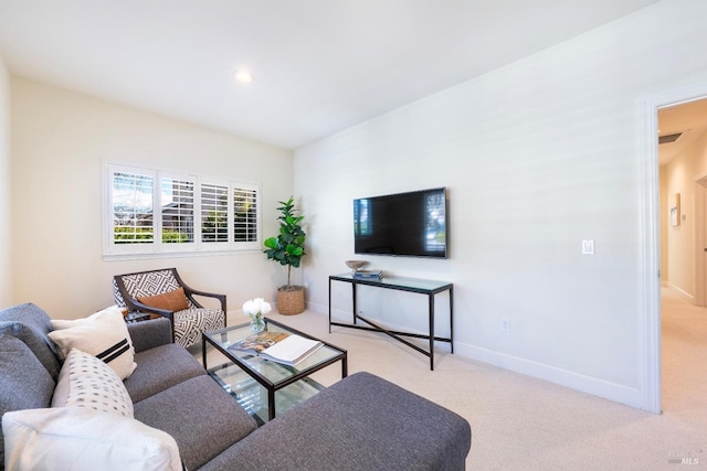 living area featuring carpet floors and baseboards