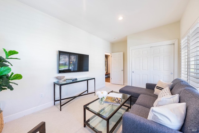 living area featuring light carpet, baseboards, and recessed lighting