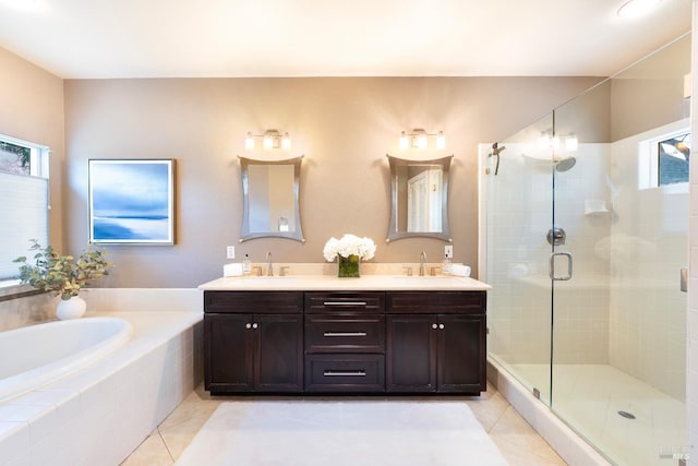 bathroom featuring a stall shower, tile patterned flooring, a sink, and a bath