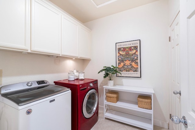 laundry room with cabinet space, light tile patterned floors, and separate washer and dryer