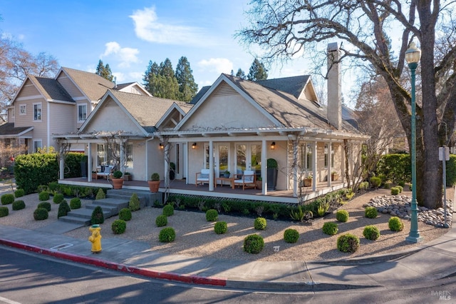 view of front of property with stucco siding and a pergola