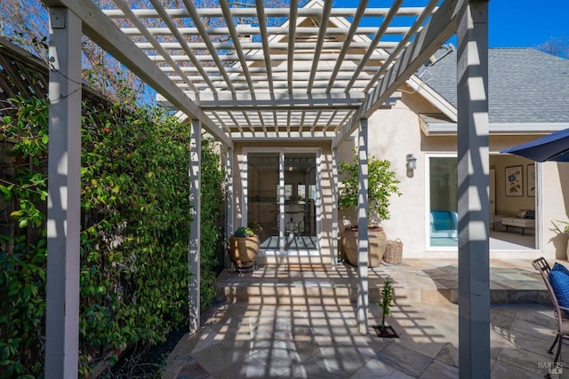 exterior space featuring a pergola, roof with shingles, a patio, and stucco siding