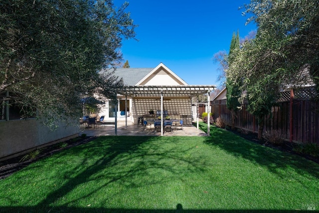 rear view of property with a yard, stucco siding, a patio area, a pergola, and a fenced backyard