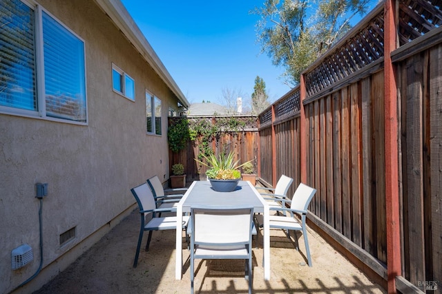 view of patio with outdoor dining area and a fenced backyard