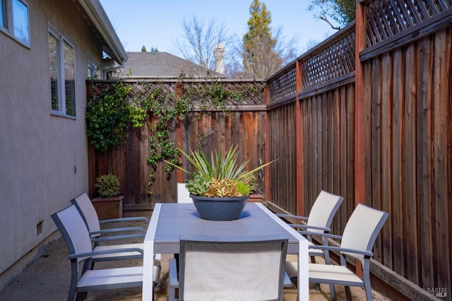 view of patio / terrace featuring fence and outdoor dining area