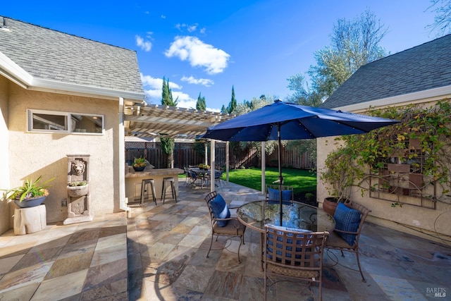 view of patio featuring outdoor dining space, a fenced backyard, outdoor dry bar, and a pergola