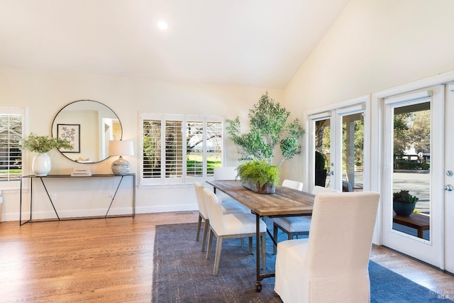 dining room with a wealth of natural light, french doors, baseboards, and wood finished floors