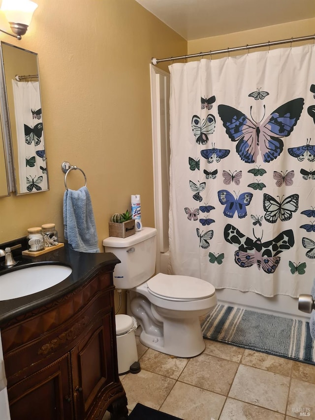 bathroom with vanity, toilet, and shower / bath combo with shower curtain