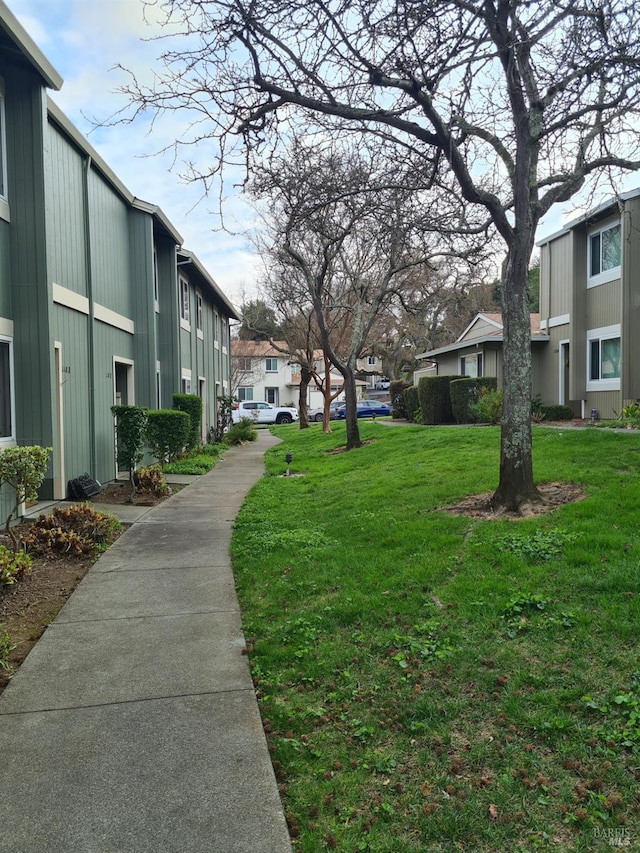 view of home's community with a lawn and a residential view