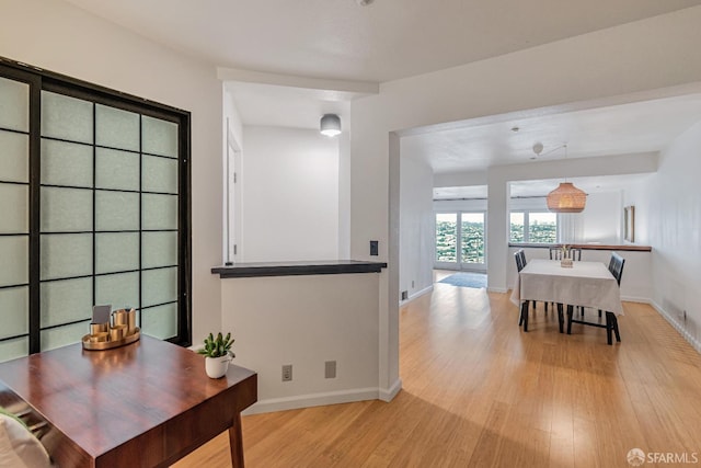interior space with light wood-style floors and baseboards