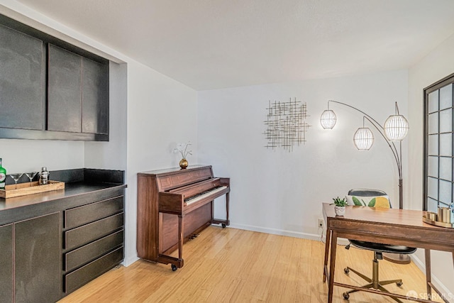 interior space featuring light wood-type flooring and baseboards