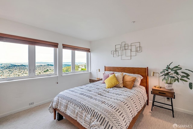 bedroom featuring baseboards and light carpet