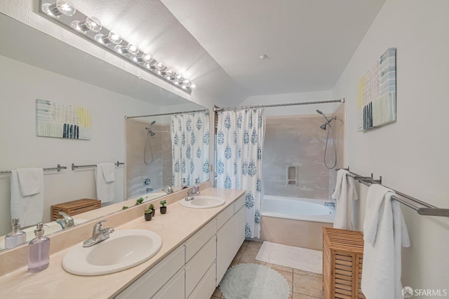 bathroom featuring tile patterned flooring, a sink, shower / bath combo, and double vanity