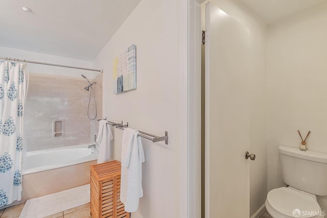 full bath with shower / tub combo, tile patterned floors, and toilet