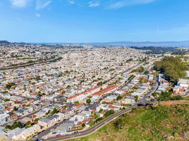 drone / aerial view featuring a residential view and a mountain view