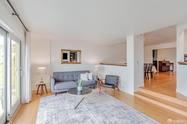 living room featuring baseboards and light wood-type flooring
