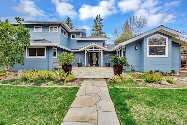 traditional-style home with a front lawn