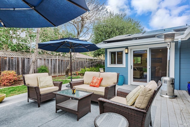 view of patio with a fenced backyard, a wooden deck, and an outdoor hangout area