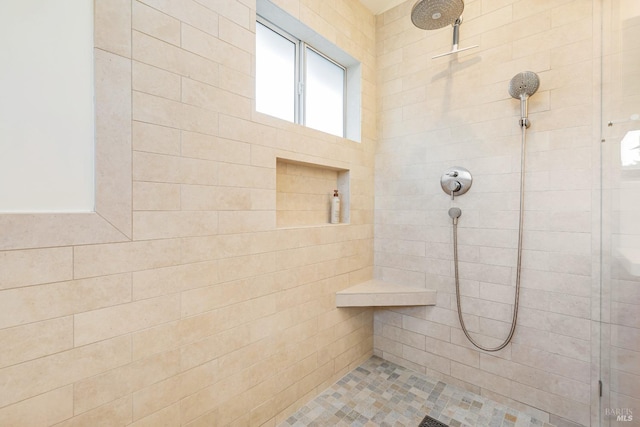 bathroom with a tile shower