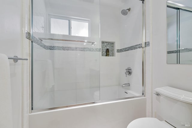 bathroom featuring toilet and enclosed tub / shower combo