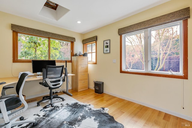 office space with baseboards, recessed lighting, and light wood-style flooring