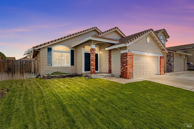 view of front facade with a garage, brick siding, fence, driveway, and a front lawn