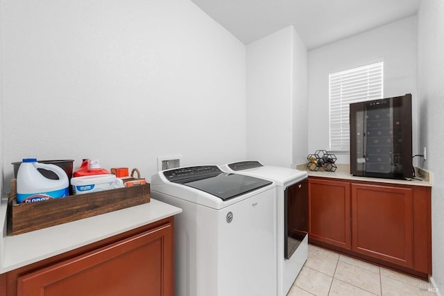 laundry room with beverage cooler, cabinet space, washer and clothes dryer, and light tile patterned floors