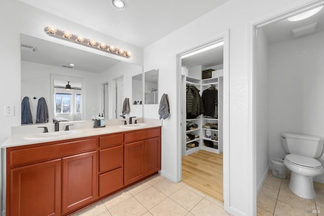 full bath featuring tile patterned flooring, visible vents, and a sink