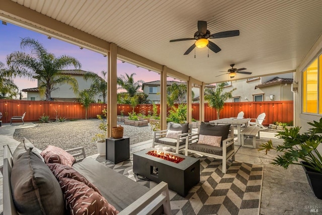 view of patio / terrace featuring outdoor dining space, a fenced backyard, and an outdoor living space with a fire pit