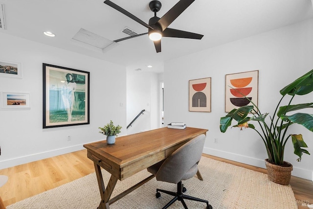 office space with visible vents, baseboards, and wood finished floors