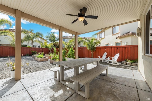 view of patio / terrace with a ceiling fan, outdoor dining space, a garden, and a fenced backyard