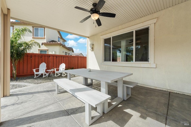 view of patio / terrace featuring ceiling fan, outdoor dining space, and fence