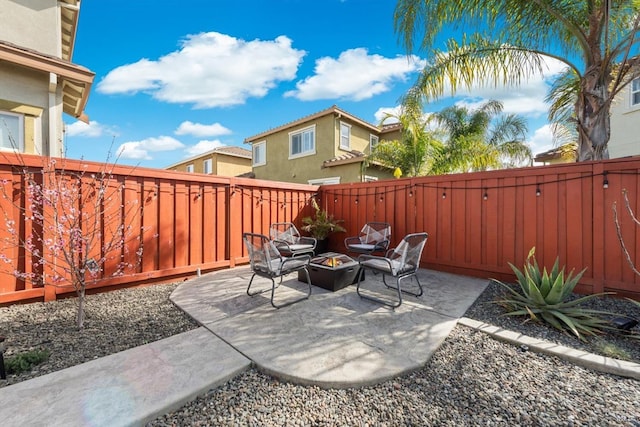 view of patio / terrace featuring a fenced backyard and a fire pit