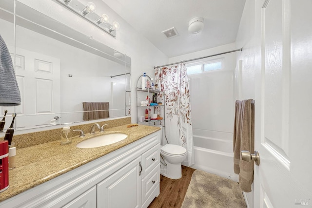 bathroom with shower / tub combo, visible vents, toilet, wood finished floors, and vanity