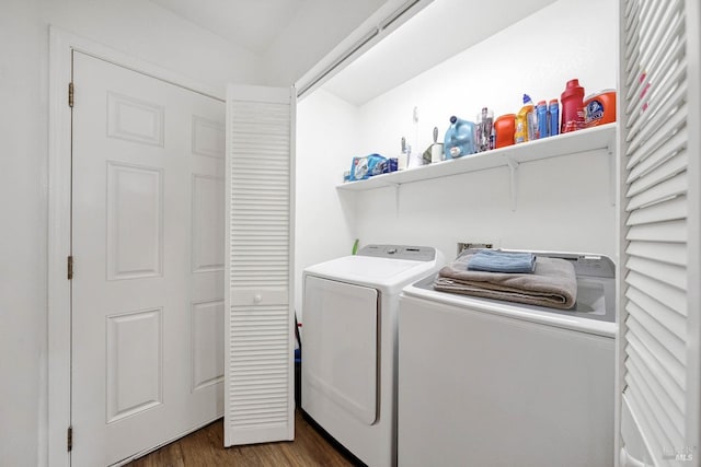 clothes washing area featuring laundry area, dark wood-style floors, and washer and clothes dryer