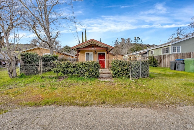 view of front of home with fence and a front yard