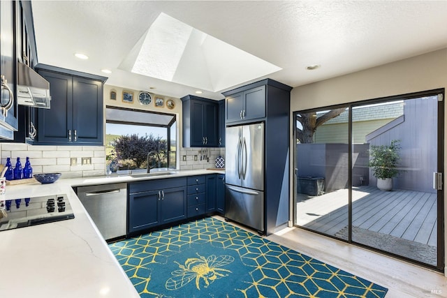 195 Condor Ct Unit 1061, Bodega Bay, CA 94923 - kitchen featuring stainless steel appliances, a sink, range hood, light stone countertops, and backsplash
