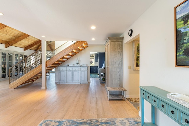 bonus room featuring light wood-type flooring, stairs, recessed lighting, baseboards, and vaulted ceiling with beams