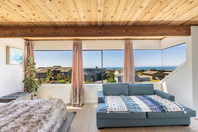 bedroom with beamed ceiling, wood ceiling, and wood finished floors