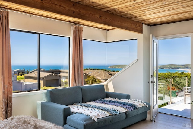 interior space with beamed ceiling, wood ceiling, and a water view