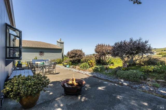 view of patio / terrace featuring outdoor dining space and an outdoor fire pit