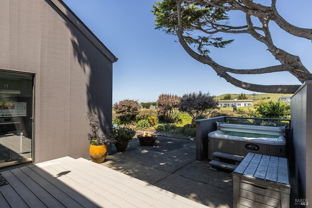 view of patio with a wooden deck and a hot tub