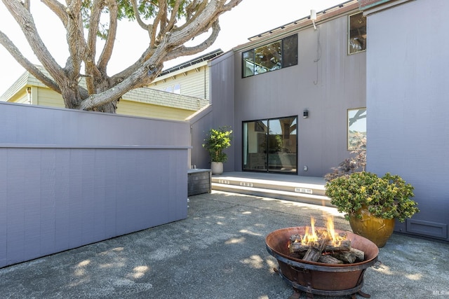 back of property featuring a patio area and an outdoor fire pit