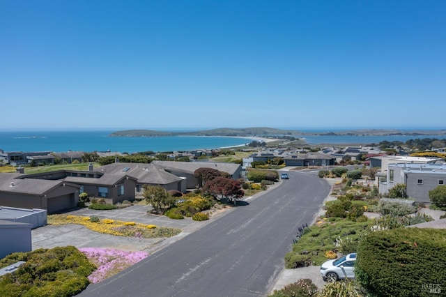 drone / aerial view with a residential view and a water view