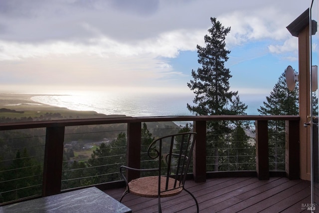 wooden terrace featuring a water view