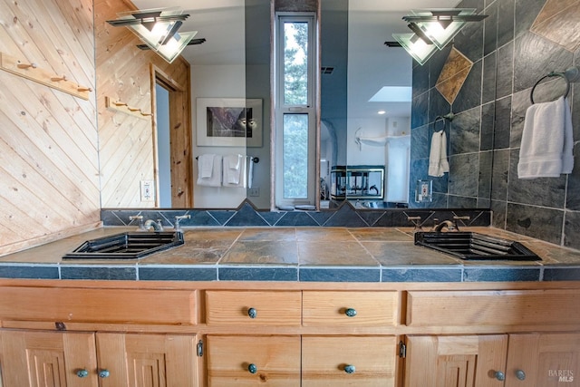 kitchen featuring light brown cabinets, a sink, and visible vents