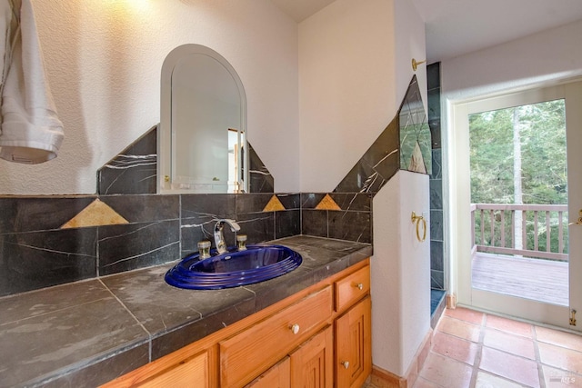 bathroom featuring tasteful backsplash, vanity, and tile patterned floors