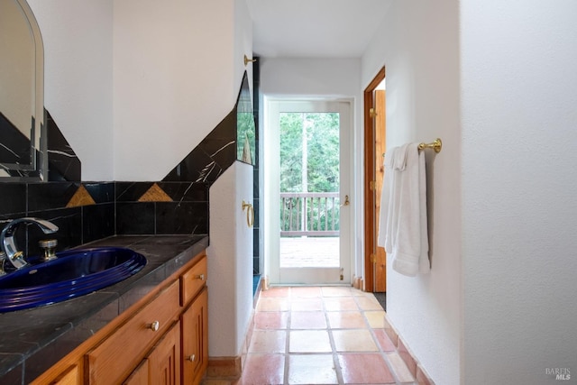 bathroom featuring tasteful backsplash, a wealth of natural light, and vanity